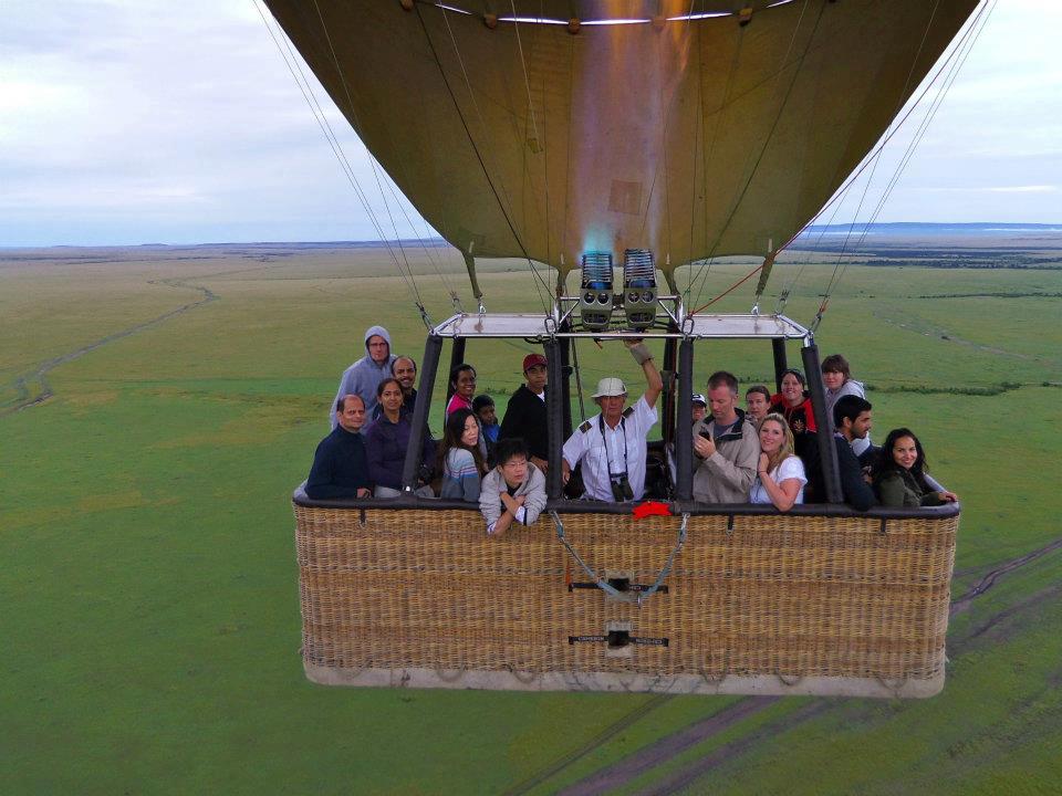 Hot air balloon floating over the Maasai Mara National Reserve at sunrise